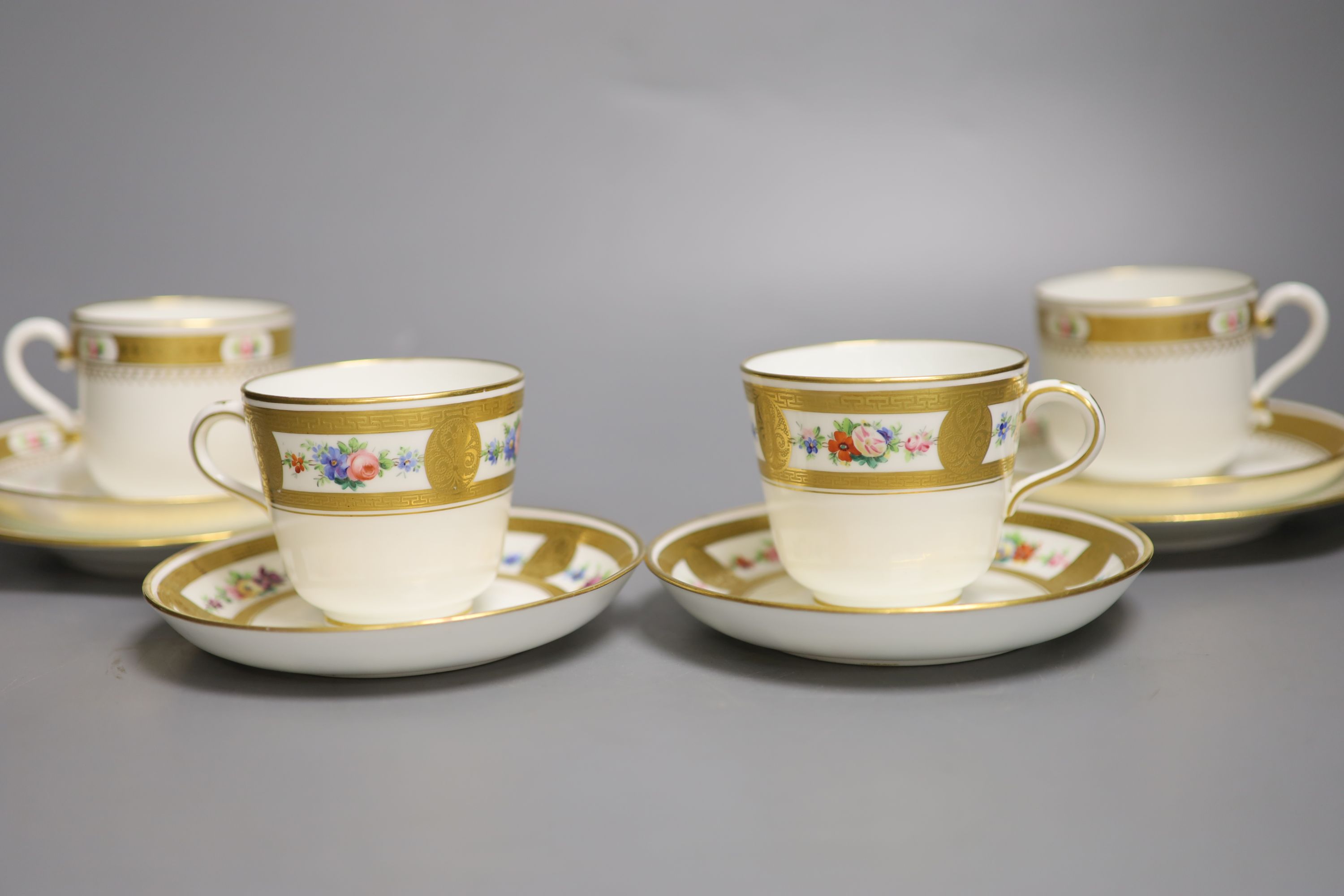 A pair of Minton coffee cups and saucers & pair Minton trios